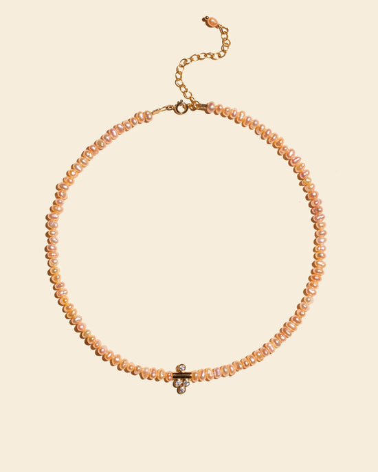 Collier Dalhia APSARA composé de fines perles nacrées roses et d'un délicat pendentif central plaqué or serti de 4 zircons brillants.
